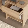 A close-up view of a wooden nightstand with an open drawer. Podgląd zdjęcia produktu