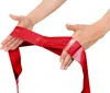 Hands holding a red Theraband fitness band. Produktbild-Vorschau