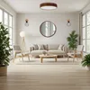 A modern living room with a sofa, chairs, coffee table, and plants, illuminated by a ceiling light and wall sconces. Anteprima dell’immagine prodotto