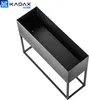 A black metal planter on a stand, shown from a high angle. Produktbild-Vorschau