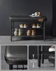 A multi-panel image showing a black shoe bench with two shelves, displaying various shoes. Close-up shots highlight the stitching detail and leg height. Produktbild-Vorschau