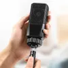 A hand holding a black audio cable adapter with a microphone-like design. Anteprima dell’immagine prodotto