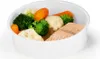 A white bowl filled with salmon and steamed vegetables including broccoli, cauliflower, and carrots. Produktbild-Vorschau