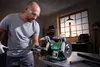 A man is using a bench grinder in a workshop. Produktbild-Vorschau