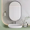 A modern bathroom vanity with a sink, mirror, and accessories. Anteprima dell’immagine prodotto