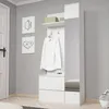 A white hallway furniture unit with a mirror, shelf, and drawers, with a white shirt hanging on a hook. Náhled obrázku produktu