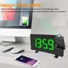A desk setup with a computer monitor, keyboard, mouse, smartphone, and a digital alarm clock. Produktbild-Vorschau
