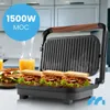 A sandwich maker with sandwiches and orange juice on a kitchen counter. Produktbild-Vorschau