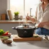 A person is cooking with a pot on a stovetop, with vegetables and spices nearby. Náhľad obrázku produktu