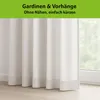 A close-up view of white curtains hanging in front of a window, with a green banner at the top containing text. Produktbild-Vorschau