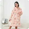 A woman is wearing a pink hoodie blanket with a rabbit pattern. Náhled obrázku produktu