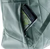 A close-up view of a smartphone with a map displayed on its screen, tucked into a pocket of a light green backpack. Produktbild-Vorschau