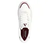 A top-down view of a white sneaker with red accents. Anteprima dell’immagine prodotto