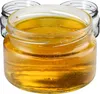 Three glass jars filled with honey are shown against a white background. The front jar is in focus, showing the texture and color of the honey. Produktbild-Vorschau