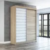 A modern sliding door wardrobe in a room with a concrete wall and wooden floor. Produktbild-Vorschau