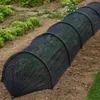 A black mesh tunnel protecting plants in a garden. Náhľad obrázku produktu