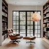 A modern living room with bookshelves, a large window, and a comfortable chair. Produktbild-Vorschau