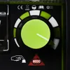 A close-up view of a control panel on a welding machine, featuring a large green dial with white and green segments indicating settings. Several regulatory icons and text are visible above the dial, and a hand pressing a button icon and a 'MODO' symbol are Produktbild-Vorschau