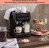 A black espresso machine with cups and donuts on a countertop. Náhľad obrázku produktu