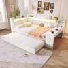 A white daybed with a pull-out trundle bed, integrated desk, and LED lighting, set in a room with decorative pictures on the wall. Produktbild-Vorschau