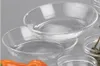 Several clear glass bowls are stacked and arranged on a gray surface. Produktbild-Vorschau