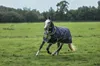 A horse wearing a dark blue turnout rug with yellow trim is running in a grassy field. Produktbild-Vorschau