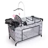 A baby playpen with a mobile and a tray attached. Produktbild-Vorschau