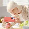 A woman is taking a picture of a bowl of strawberries with her phone, which is in a protective case. Produktbild-Vorschau