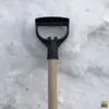 A close-up view of the handle and upper part of a shovel against a snowy background. Náhľad obrázku produktu