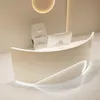 A modern reception desk with a curved design and integrated lighting. Produktbild-Vorschau