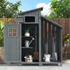A garden shed filled with gardening tools and accessories, set outdoors against a backdrop of trees and a wooden fence. Produktbild-Vorschau