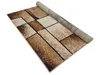 A rectangular rug with a geometric pattern is partially unrolled on a white background. Náhled obrázku produktu