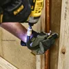 A person wearing work gloves is using a DeWALT drill with a flexible extension to screw into a wooden structure near a copper pipe. Náhled obrázku produktu