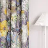 A close-up of a floral patterned curtain next to a white lamp. Produktbild-Vorschau