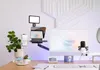 A desk setup with a computer, teleprompter, microphone, and other accessories. Náhľad obrázku produktu