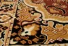 A close-up view of a patterned rug with intricate floral and paisley designs. Voir les images du produit