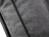 A close-up view of a grey fabric cushion with a black trim. Náhľad obrázku produktu