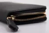 A close-up shot of a black wallet with a gold zipper. Produktbild-Vorschau