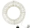 A white wire wreath with lights and a plug. Produktbild-Vorschau