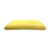 A yellow pillow with perforations, shown from the side. Produktbild-Vorschau