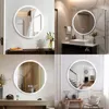 A collage of four images showcasing round LED bathroom mirrors in different home settings. Produktbild-Vorschau