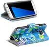 Two views of a Samsung Galaxy S7 Edge phone in a blue floral patterned flip case. Produktbild-Vorschau