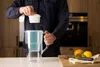 A person is inserting a filter into a water pitcher in a kitchen setting. Náhľad obrázku produktu