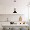 A modern kitchen with white cabinets, a herringbone backsplash, and a kitchen island with a pendant light hanging above it. Produktbild-Vorschau