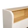 A close-up view of the side and top of a bed frame, showing the upholstered headboard and a wooden shelf. Náhled obrázku produktu