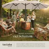 People enjoying a gathering under a large umbrella in a garden setting. Produktbild-Vorschau