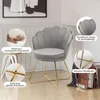 A gray velvet accent chair with gold metal legs is shown in a room setting, with close-up insets highlighting its features. Voir les images du produit