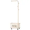 A white coat rack with a storage basket and wheels. Produktbild-Vorschau