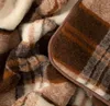 A close-up view of a plaid blanket. Produktbild-Vorschau