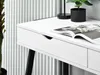 A close-up view of a white desk with black legs, showing a drawer and an open magazine. Voir les images du produit